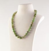 SINGLE STRAND NECKLACE of 43 pale green jade uniform round beads, 19in (48.2cm) long