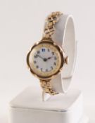 RIVAL, LADY'S 9ct GOLD WRISTWATCH with 15 jewels movement, gilt decorated white porcelain Arabic