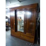 AN EDWARDIAN INLAID MAHOGANY WARDROBE WITH CENTRE MIRROR DOOR, END PANEL DOORS AND TWO DRAWERS