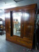 AN EDWARDIAN INLAID MAHOGANY WARDROBE WITH CENTRE MIRROR DOOR, END PANEL DOORS AND TWO DRAWERS