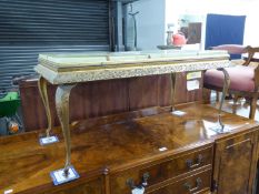 A GILT OBLONG COFFEE TABLE WITH SIMULATED ONYX TOP