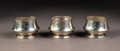 GEORGE VI SET OF THREE PLAIN SILVER OPEN SALTS, of circular, footed form, two with clear glass