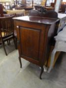 A MAHOGANY MUSIC CABINET WITH BEADED AND CARVED FRONT DECORATION HAVING INTERNAL SHELVING