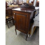 A MAHOGANY MUSIC CABINET WITH BEADED AND CARVED FRONT DECORATION HAVING INTERNAL SHELVING