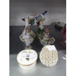 A PAIR OF SMALL EARLY TWENTIETH CENTURY CONTINENTAL PORCELAIN FLORAL ENCRUSTED TWO HANDLED VASES