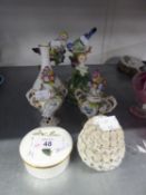 A PAIR OF SMALL EARLY TWENTIETH CENTURY CONTINENTAL PORCELAIN FLORAL ENCRUSTED TWO HANDLED VASES