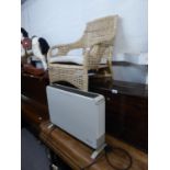 A WICKER CONSERVATORY ARMCHAIR AND AN ELECTRIC CONVECTOR HEATER (2)