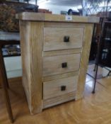 A LIMED OAK SMALL CHEST OF THREE DRAWERS