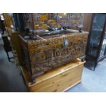 CHINESE CARVED CAMPHOR WOOD BLANKET CHEST CAVÉ RELIEVO WITH FIGURES AND SCENES, RAISED ON FEET, 2?