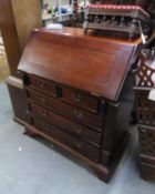 A MAHOGANY GEORGIAN STYLE SMALL BUREAU, THE SLOPING FALL-FRONT ENCLOSING A WELL-FITTED INTERIOR, TWO