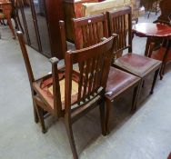 A SET OF FOUR OAK RAIL BACK DINING CHAIRS, WITH DROP-IN SEATS, INCLUDING A CARVER?S ARMCHAIR (4)