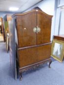 A QUEEN ANNE STYLE BURR WALNUT COCKTAIL CABINET, THE UPPER SECTION HAVING FITTED INTER WITH GLASS