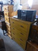 A PAIR OF MODERN PINE THREE DRAWER BEDSIDE CHESTS AND A WOOD EFFECT MELAMINE CHEST OF FOUR LONG