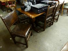 AN EARLY TWENTIETH CENTURY OAK TRESTLE END DINING  TABLE (6' X 2'8")  AND SIX OAK AND LEATHER