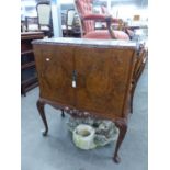 A CAROLEAN STYLE FIGURED WALNUT WOOD TWO DOOR COCKTAIL CABINET