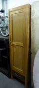 A LIGHT OAK NARROW WARDROBE WITH SINGLE DOOR AND DRAWER IN BASE, 1?9? WIDE