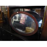 A LARGE OVAL BEVELLED EDGE WALL MIRROR, IN MAHOGANY, BEADED INNER-EDGE FRAME