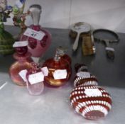 A RUBY GLASS AND WHITE ENAMELLED FLATTENED GOURD SHAPED PERFUME FLASK WITH METAL COVER, ALSO FIVE