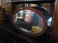 A LARGE OVAL BEVELLED EDGE WALL MIRROR, IN MAHOGANY, BEADED INNER-EDGE FRAME