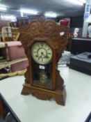 AN EARLY TWENTIETH CENTURY AMERICAN ANSONIA CLOCK CO. SHELF CLOCK, IN CARVED OAK CASE, 22 3/4" (