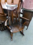 AN ERCOL DARKWOOD SPINDLE BACK ROCKING CHAIR