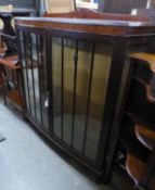 A MAHOGANY DWARF DISPLAY CABINET WITH TWO GLAZED DOORS TO THE BOW FRONT, ON STUMP CABRIOLE SUPPORTS,