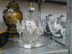 A CUT GLASS WINE JUG SET OF FOUR CUT GLASS SMALL STEM WINES OR LIQUEURS ON A CUT GLASS CIRCULAR TRAY