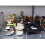 FOUR CERAMIC FIGURAL ORNAMENTS, ON MUSICAL BASES; THREE METAL CIRCULAR MUSICAL BOXES AND A MUSICAL