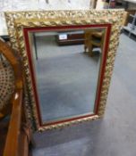 RECTANGULAR BEVELLED EDGE WALL MIRROR IN FOLIATE SCROLL EMBOSSED GILT FRAME WITH PINK VELVET INSERT,