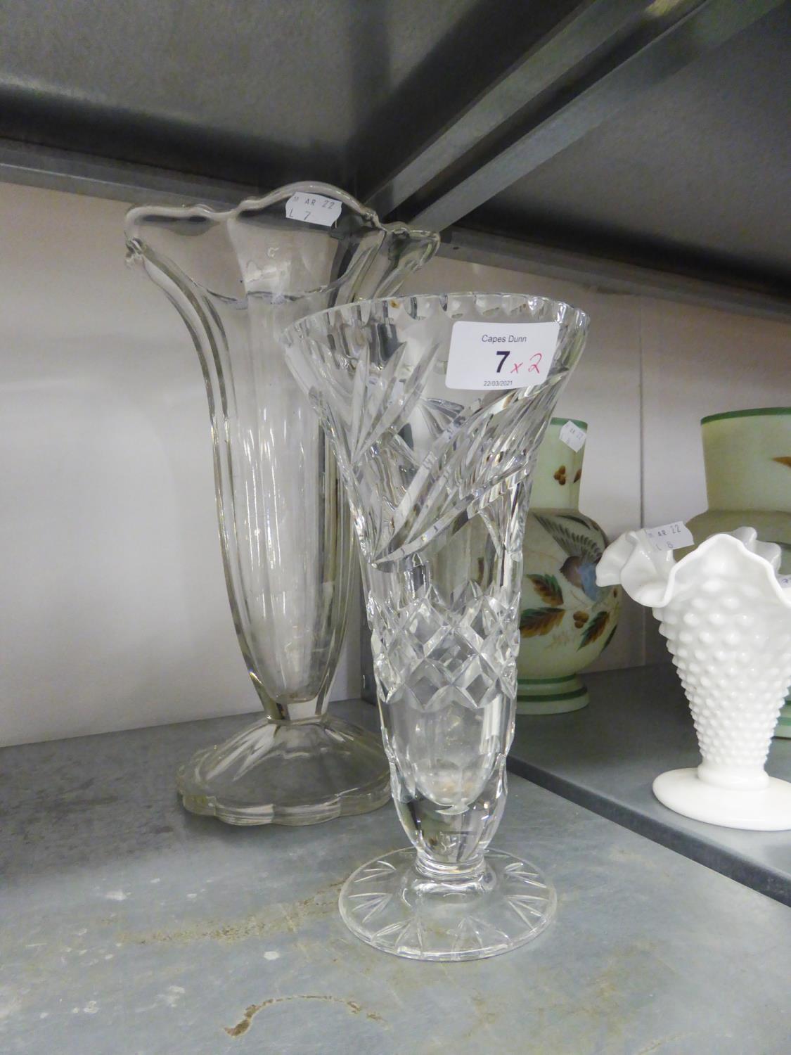 A CUT GLASS TRUMPET VASE AND A LARGE MOULDED GLASS TRUMPET VASE