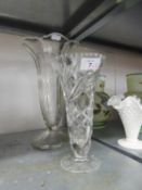 A CUT GLASS TRUMPET VASE AND A LARGE MOULDED GLASS TRUMPET VASE