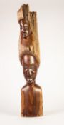 AFRICAN HARDWOOD TREE BRANCH CARVED AND POLISHED WITH TWO FEMALE HEADS, one above the other or as