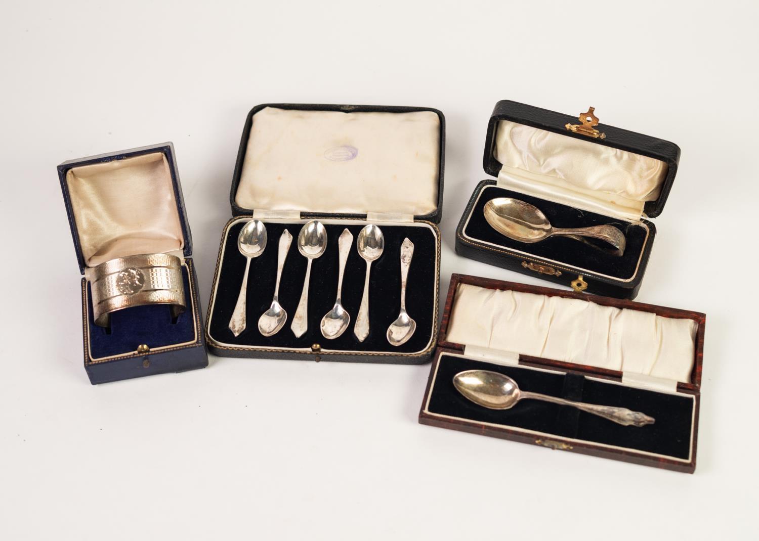 * BOXED ENGINE TURNED SILVER OVAL NAPKIN RING; a CHILD'S SILVER SPOON with loop handle, in plush