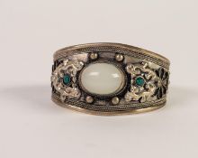 BROAD SILVER COLOURED METAL TORQUE BANGLE, the top collet set with a large oval cabochon moonstone