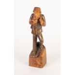 EUROPEAN CARVED SOFTWOOD FIGURE OF A WOODSMAN carrying his axe over his shoulder and smoking a pipe,
