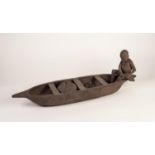 MODERN AFRICAN DARK STAINED TERRA COTTA GROUP OF A BOY PADDLING A CANOE, with basket of fish and a