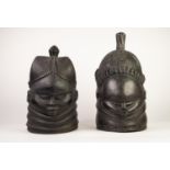 TWO AFRICAN MENDE BUNDU HOLLOW CARVED AND EBONIZED SOFTWOOD CEREMONIAL MASKS, one carved with female