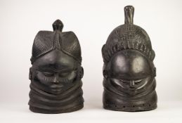 TWO AFRICAN MENDE BUNDU HOLLOW CARVED AND EBONIZED SOFTWOOD CEREMONIAL MASKS, one carved with female