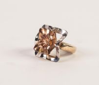 9ct THREE COLOUR GOLD DRESS RING with large square wavy two-tier top surmounted by a flower head,