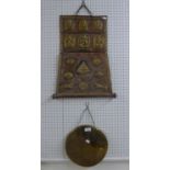 EGYPTIAN ENGRAVED BRASS DINNER GONG, 10 1/2in (26.6cm) diameter AND AN EASTERN EMBOSSED COPPER MURAL