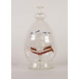 20th CENTURY GLASS FOUR-MASTED SQUARE RIGGED SHIP IN A DECANTER FORM OVOID BOTTLE, the ship with