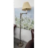 A BRASS FLOOR LAMP WITH SWINGING ARM TOP AND FABRIC SHADE