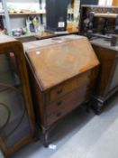 A SMALL MAHOGANY BUREAU, HAVING FALL DOWN FRONT TO REVEAL SEMI-FITTED INTERIOR AND THREE DRAWERS