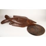 AFRICAN CARVED HARDWOOD LIFE-SIZE PLAQUE OF A CARNIVOROUS SCALY FISH, with long pectoral fin,