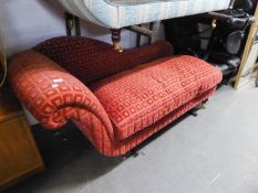 A CHAISE LONGUE WITH SINGLE SCROLL END, COVERED IN WINE RED EMBOSSED CUT VELVET, ON MAHOGANY TOUPE