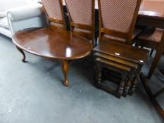 A NEST OF THREE JACOBEAN STYLE OAK OBLONG COFFEE TABLES AND A LARGE WALNUT OVAL COFFEE TABLE, ON