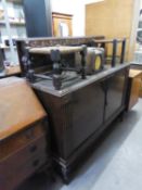 A 1930's GOOD QUALITY OAK SIDEBOARD WITH LOW CARVED BACK, HAVING TWO SOLID DOORS, INTERIOR WITH