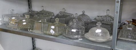 A LARGE COLLECTION OF MOULDED GLASS OBLONG CHEESE OR BUTTER DISHES AND COVERS, ALSO FOUR ROUND