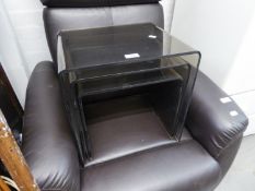 A NEST OF THREE SMOKE GREY PERSPEX COFFEE TABLES, (largest 40cm high x 41cm wide x 33cm deep)