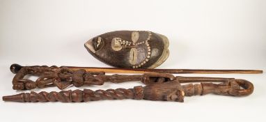 TWO AFRICAN CARVED HARDWOOD WALKING STICKS, one carved with balancing figures and an encapsulated